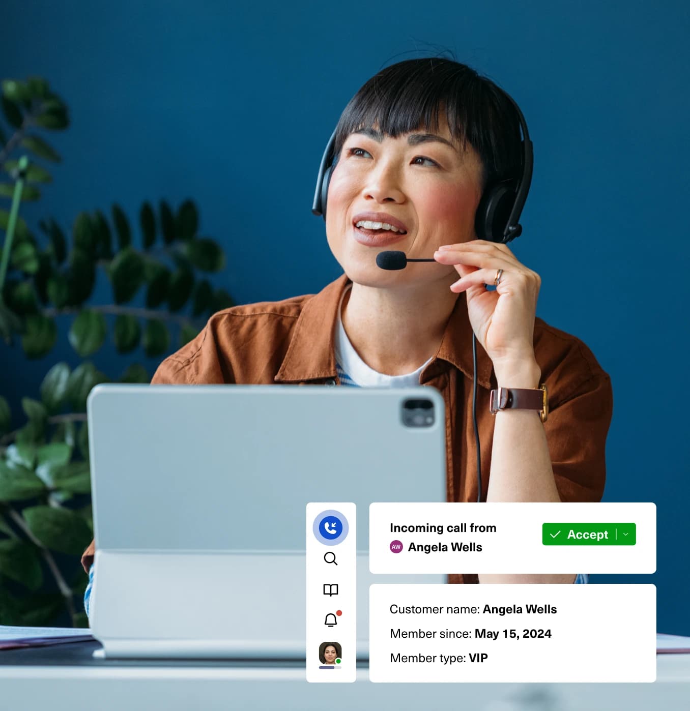 A woman wearing a headset sits at a desk with a laptop, smiling while on a call. On the screen, a notification shows an incoming call from Angela Wells, a VIP member since May 15, 2024.