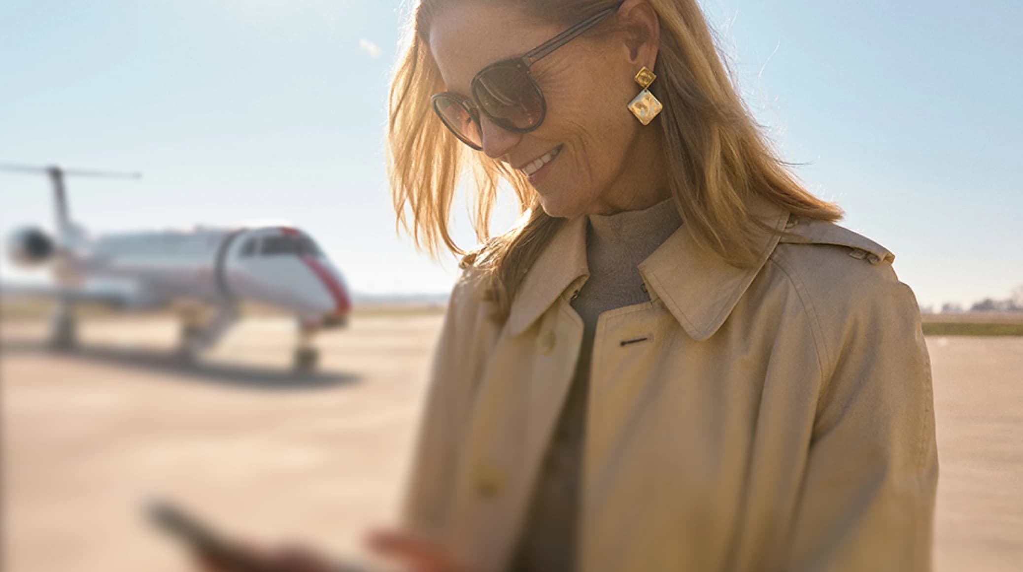 A traveler checking her phone at the airport