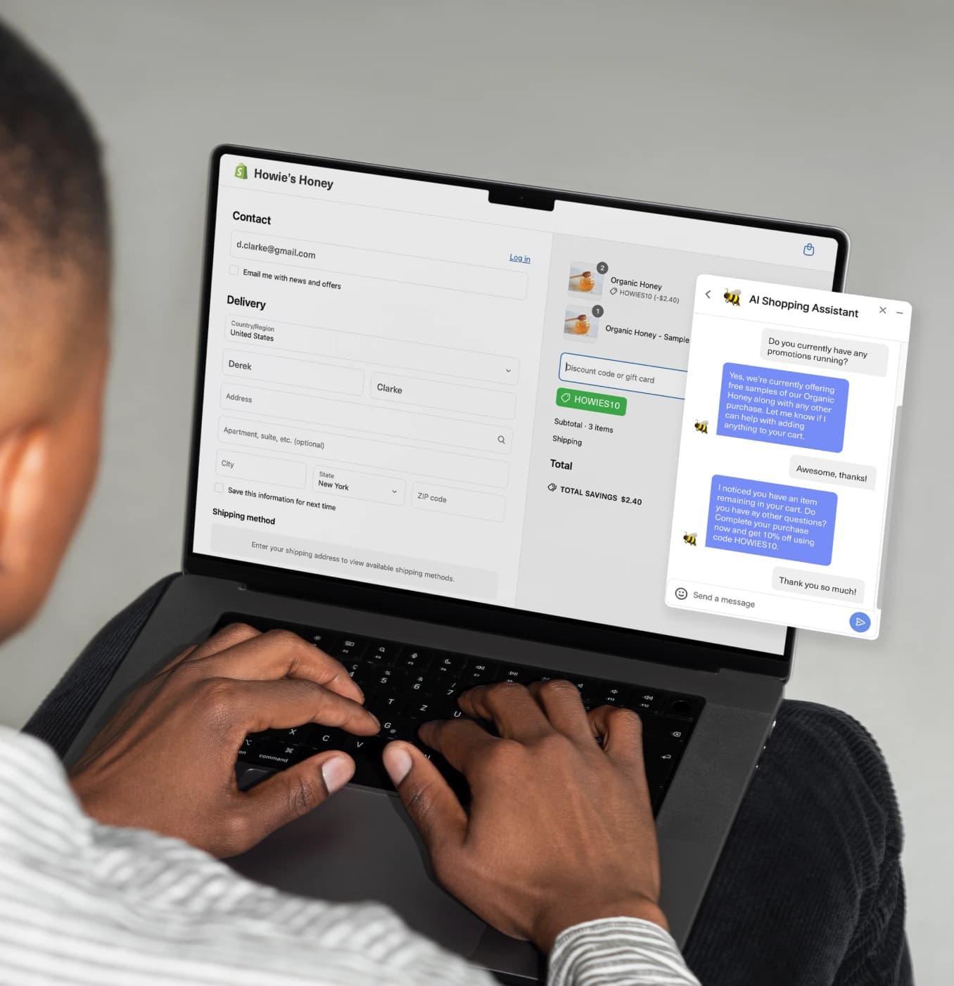 A person types on a laptop displaying a checkout page with delivery details and an AI shopping assistant chat window.