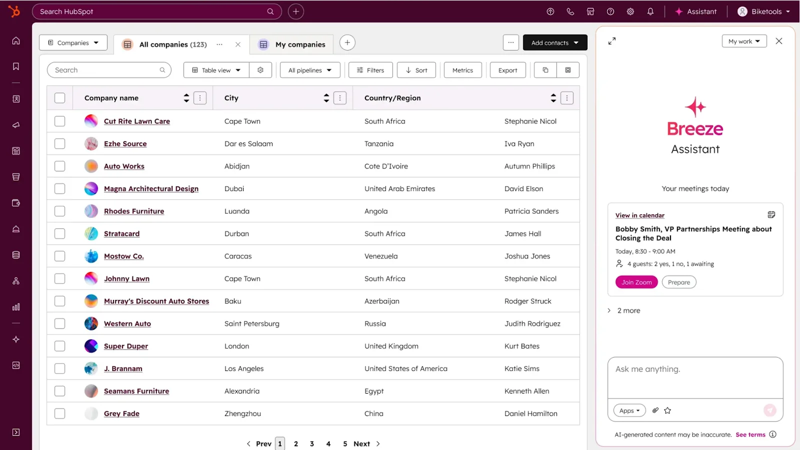 A CRM dashboard displays a list of companies with columns for name, city, country/region, owner, and checkboxes. A sidebar on the right features a Breeze Assistant chat suggesting a daily summary and meeting details—perfect content for your next newsletter.