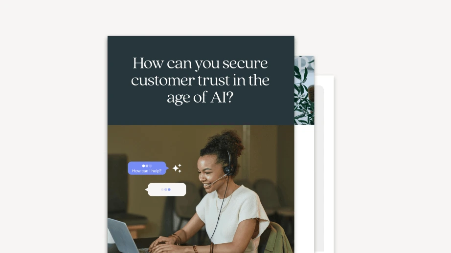 A woman wearing a headset smiles while typing on a laptop, with chat bubbles appearing on the screen. Above her, text reads: &ldquo;How can you secure customer trust in the age of AI? Discover tips from our Black Friday Cyber Monday 2025 ecommerce playbook.&rdquo;.